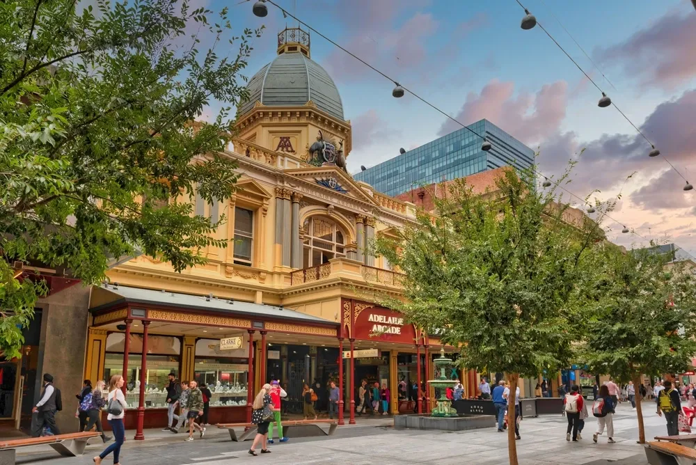 A bustling town square with people walking around the buildings in Adelaide, Australia